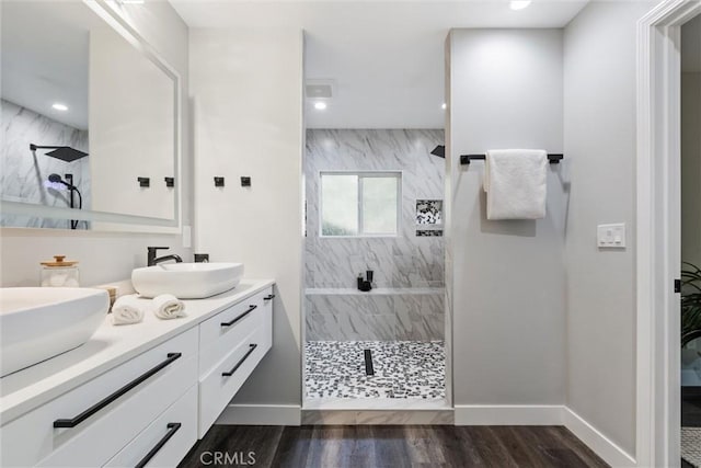 3078 Wilton Dr, Cambria, CA 93428 - full bathroom with walk in shower, double vanity, wood finished floors, and recessed lighting