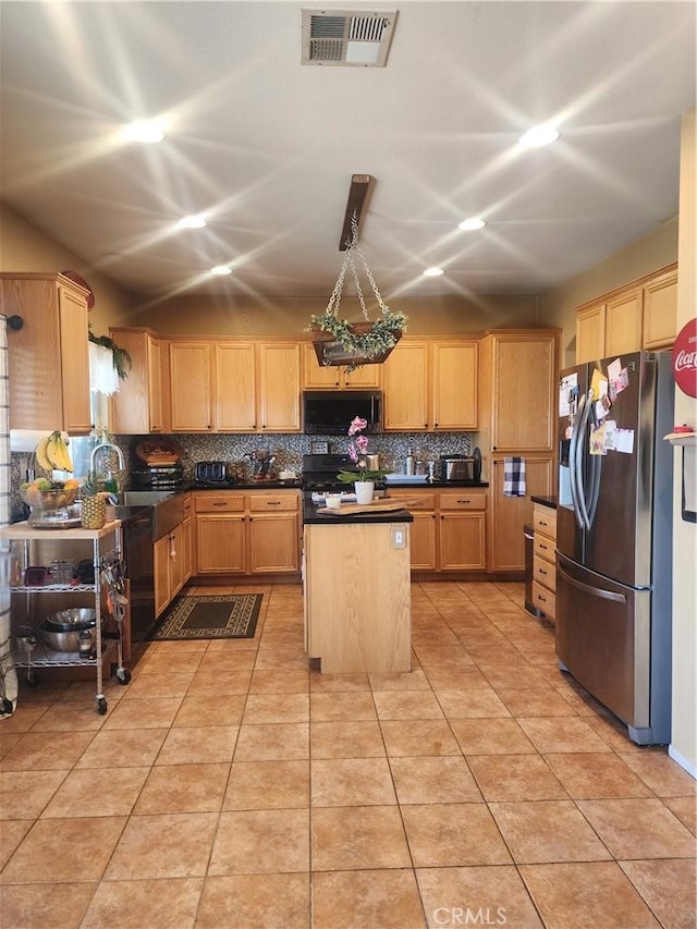 kitchen featuring sink, a center island, light brown cabinets, backsplash, and black appliances