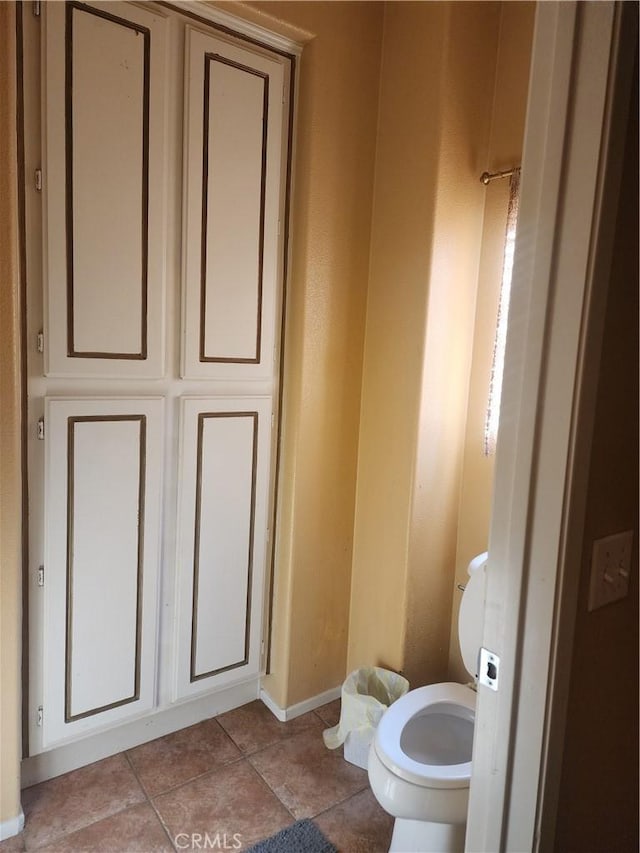 bathroom with tile patterned flooring and toilet