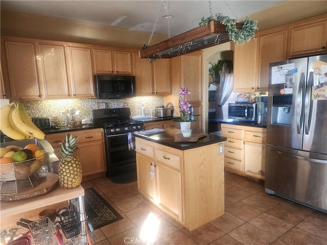 kitchen featuring black appliances, tile patterned flooring, a center island, and decorative backsplash