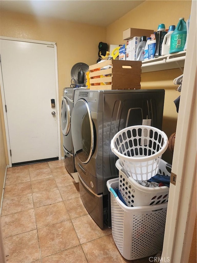 washroom featuring light tile patterned floors and washer and clothes dryer