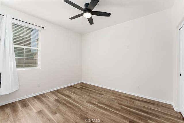 empty room with wood-type flooring and ceiling fan