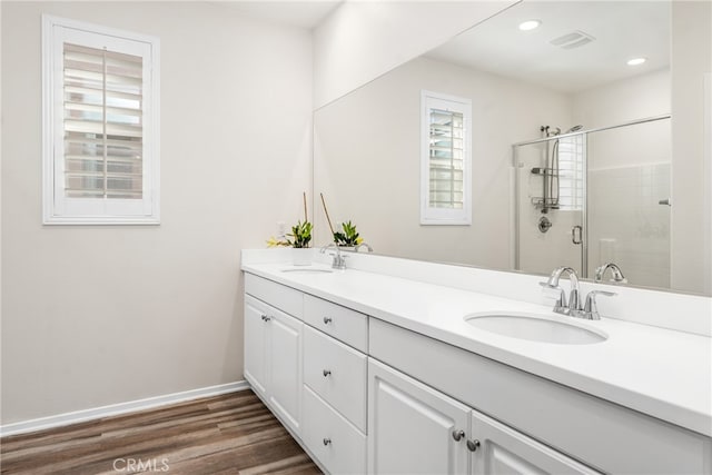 bathroom featuring a shower with door, hardwood / wood-style flooring, and vanity