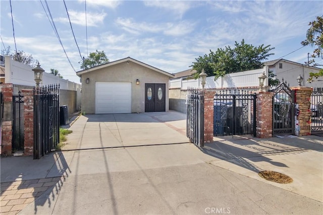 10125 Sharp Ave, Arleta, CA 91331 - view of front of house featuring concrete driveway, an outbuilding, stucco siding, a fenced front yard, and a gate