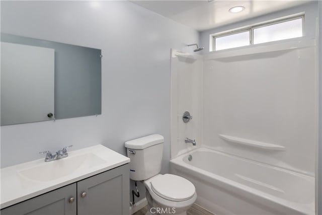 full bathroom featuring bathing tub / shower combination, vanity, and toilet