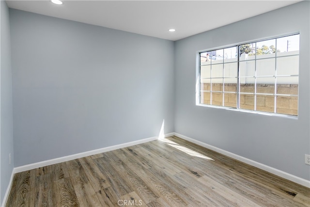 unfurnished room with light wood-type flooring