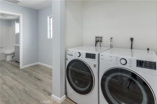 10125 Sharp Ave, Arleta, CA 91331 - laundry area with washing machine and clothes dryer, light wood finished floors, and baseboards
