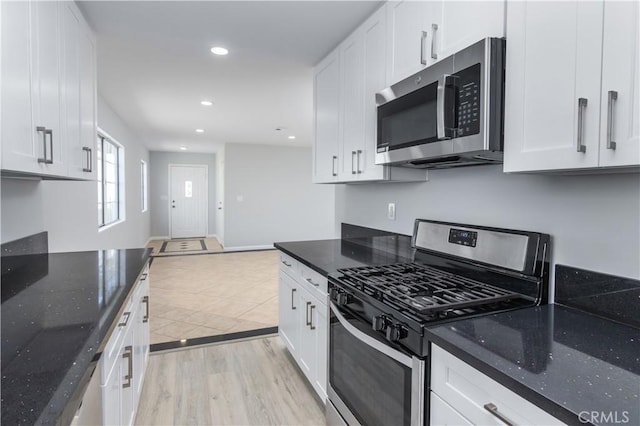 10125 Sharp Ave, Arleta, CA 91331 - kitchen with stainless steel appliances, white cabinets, dark stone counters, and recessed lighting