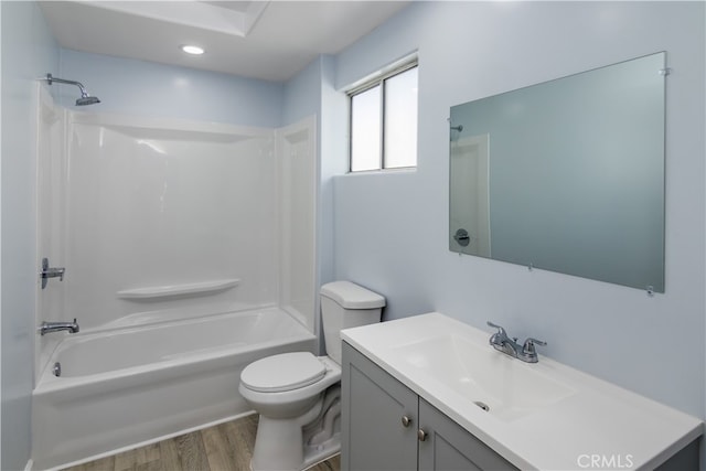 full bathroom with washtub / shower combination, wood-type flooring, vanity, and toilet