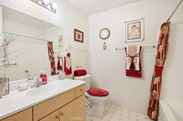 bathroom with vanity, tile patterned floors, and toilet