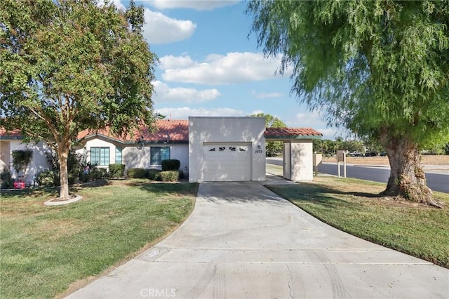 view of front of house with a garage and a front lawn