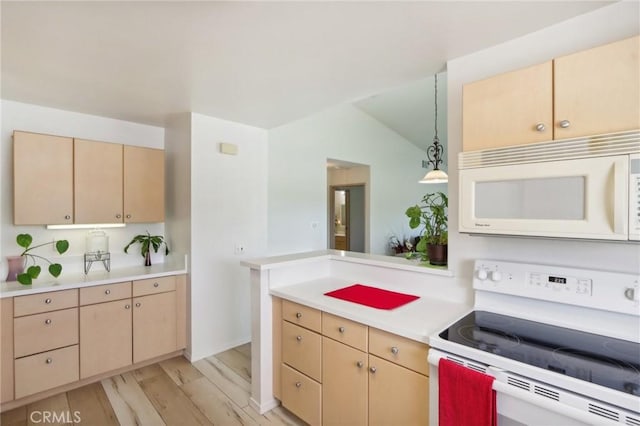 kitchen featuring pendant lighting, light wood-style flooring, light brown cabinets, white appliances, and light countertops