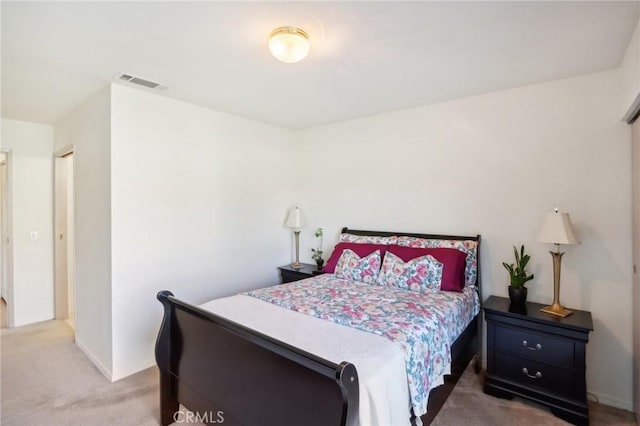 bedroom with visible vents, baseboards, and carpet