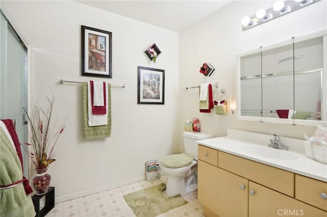 full bathroom featuring tile patterned floors, baseboards, toilet, and vanity