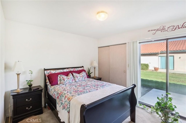 bedroom featuring a closet, carpet, and access to outside