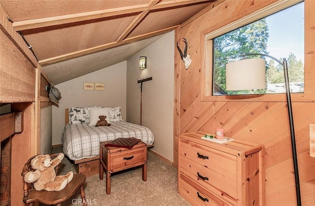 bedroom featuring carpet, wood walls, and vaulted ceiling