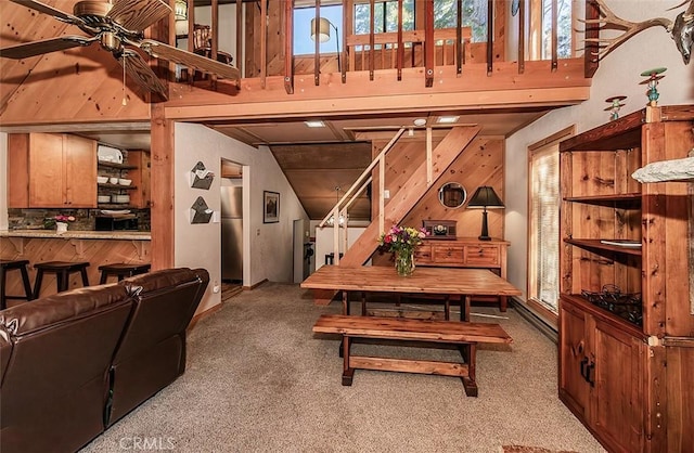 dining space with ceiling fan and carpet floors