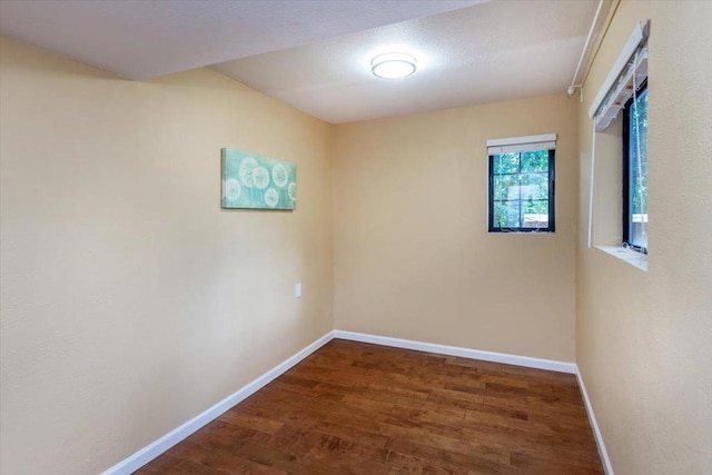 spare room with dark hardwood / wood-style flooring