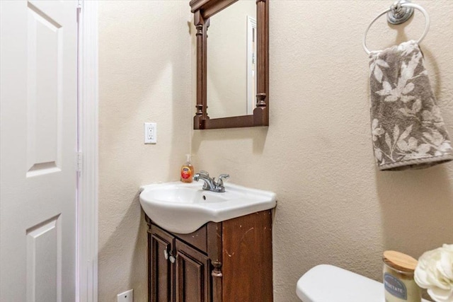 bathroom with toilet and vanity