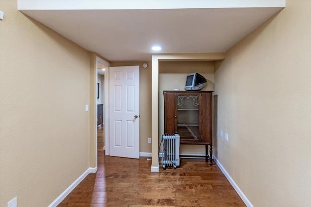 hall featuring radiator and dark wood-type flooring