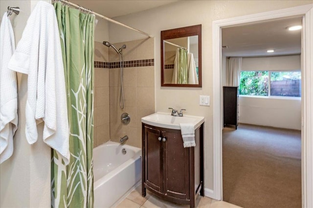 bathroom with tile patterned floors, vanity, and shower / bath combo with shower curtain