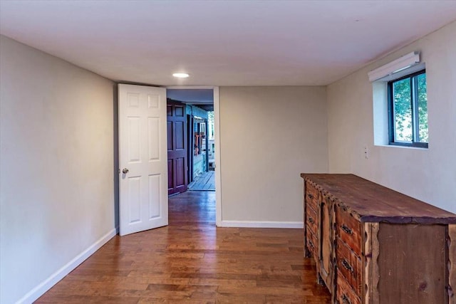 corridor with dark hardwood / wood-style flooring