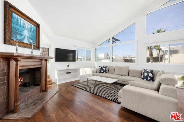 living room featuring dark hardwood / wood-style floors and high vaulted ceiling