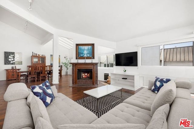 living room with dark hardwood / wood-style flooring and high vaulted ceiling