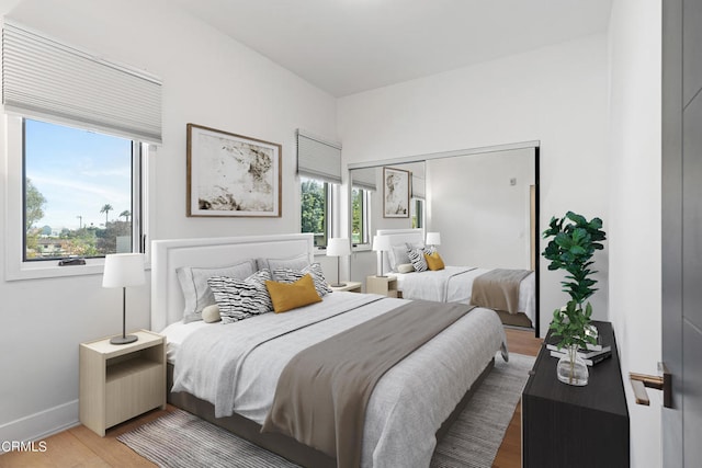 bedroom with wood-type flooring and a closet