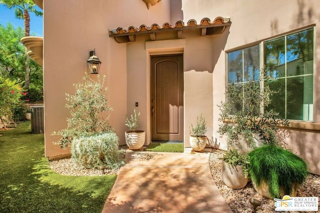 doorway to property featuring a yard