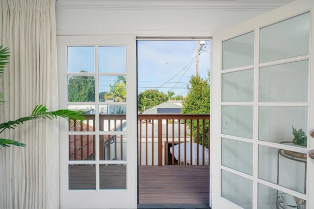 doorway to outside featuring ornamental molding and hardwood / wood-style flooring