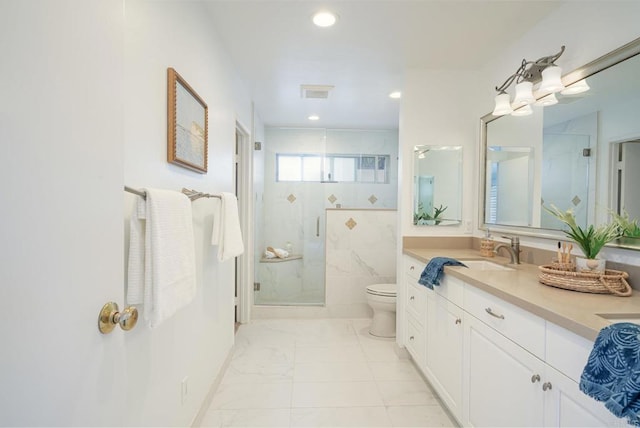 bathroom featuring tile walls, a shower with shower door, vanity, and toilet