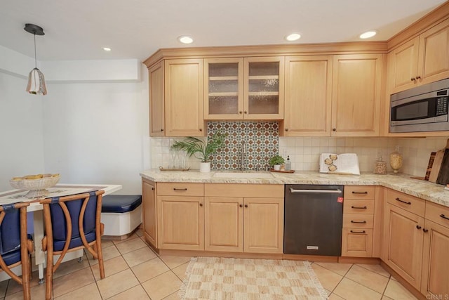 kitchen featuring light brown cabinetry, pendant lighting, appliances with stainless steel finishes, and sink