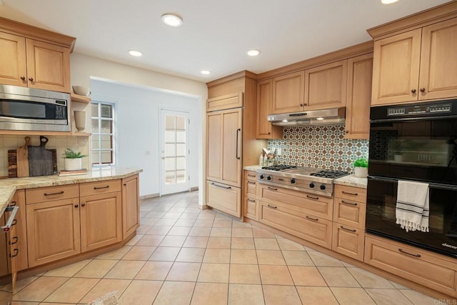 kitchen with built in appliances, light stone countertops, light tile patterned floors, and decorative backsplash