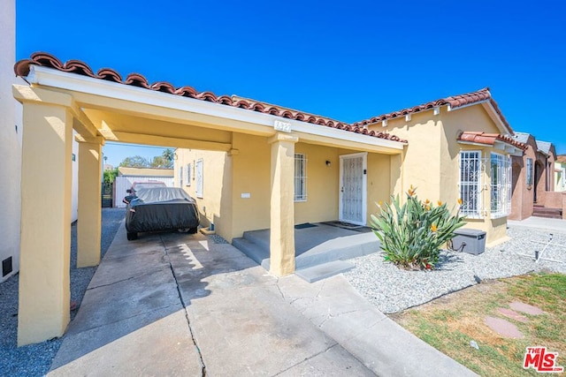 mediterranean / spanish home featuring a patio