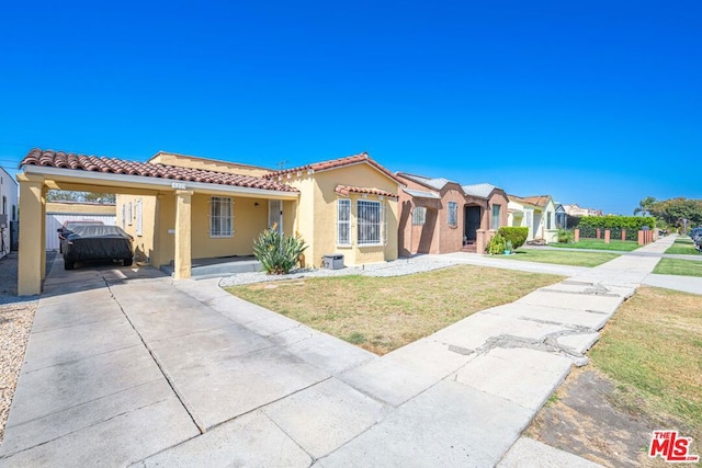 mediterranean / spanish-style house with a carport and a front yard