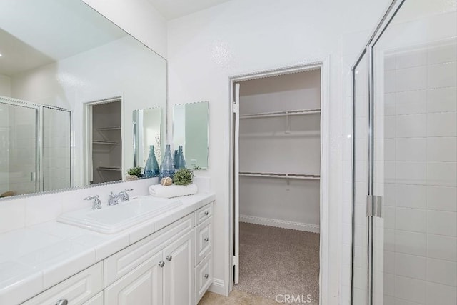 bathroom with vanity and a shower with shower door