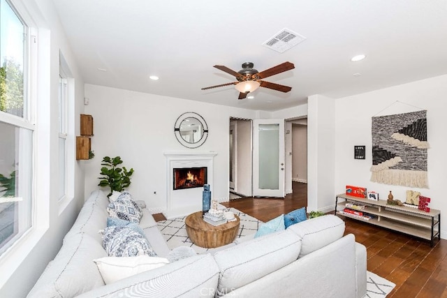 living room with hardwood / wood-style flooring and ceiling fan