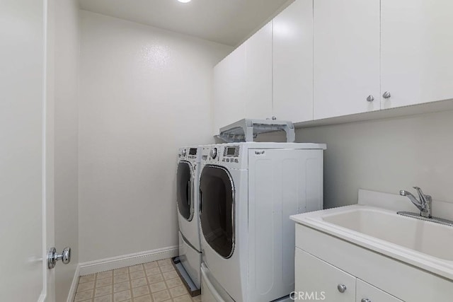 washroom featuring cabinets, separate washer and dryer, and sink