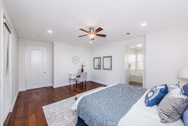 bedroom featuring ceiling fan, ensuite bathroom, dark wood-type flooring, and a textured ceiling