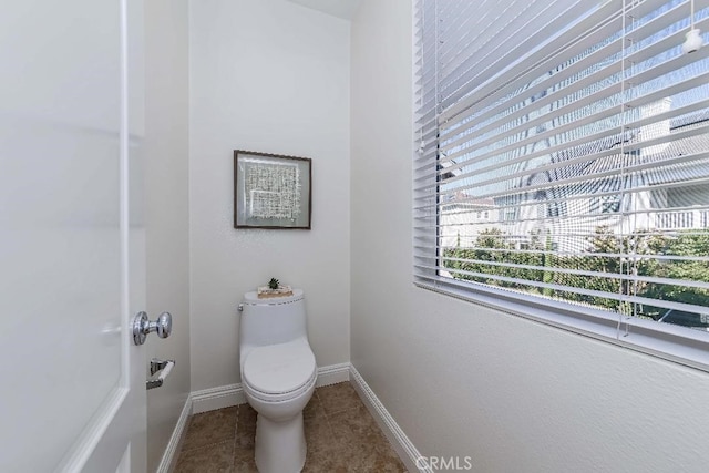 bathroom featuring tile patterned floors and toilet