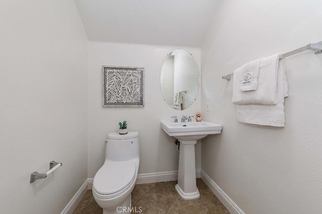 bathroom with tile patterned flooring and toilet