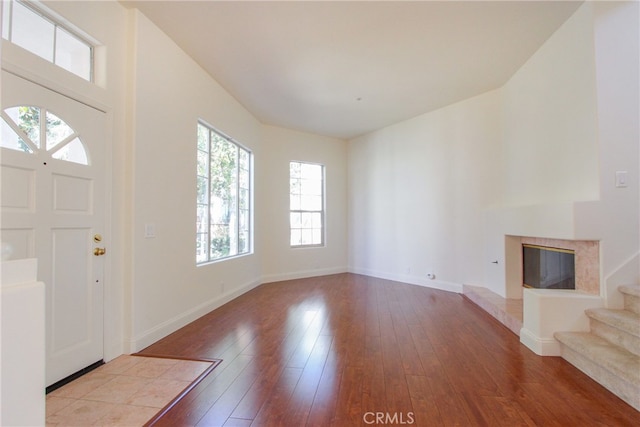 entryway featuring a fireplace and light hardwood / wood-style flooring