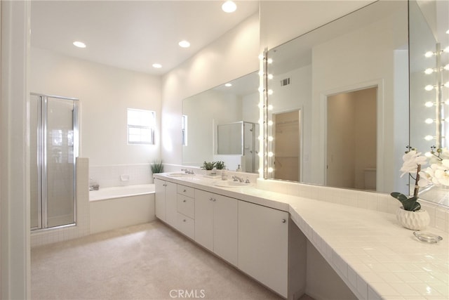 bathroom with separate shower and tub and vanity