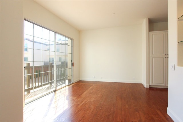 empty room with dark wood-type flooring