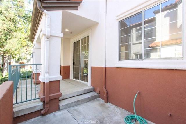 view of exterior entry featuring covered porch