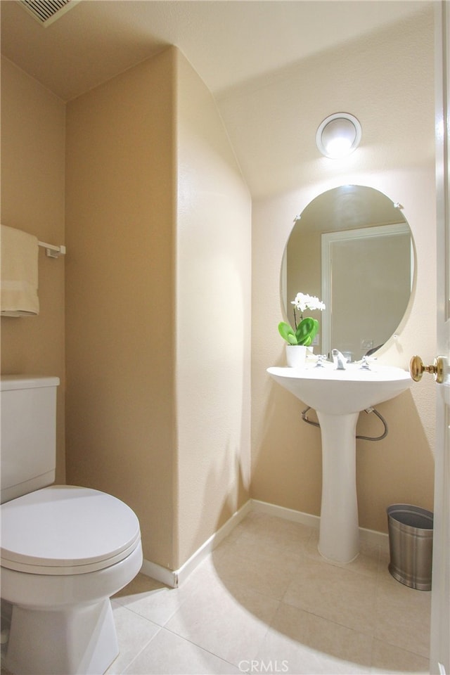 bathroom with tile patterned flooring and toilet