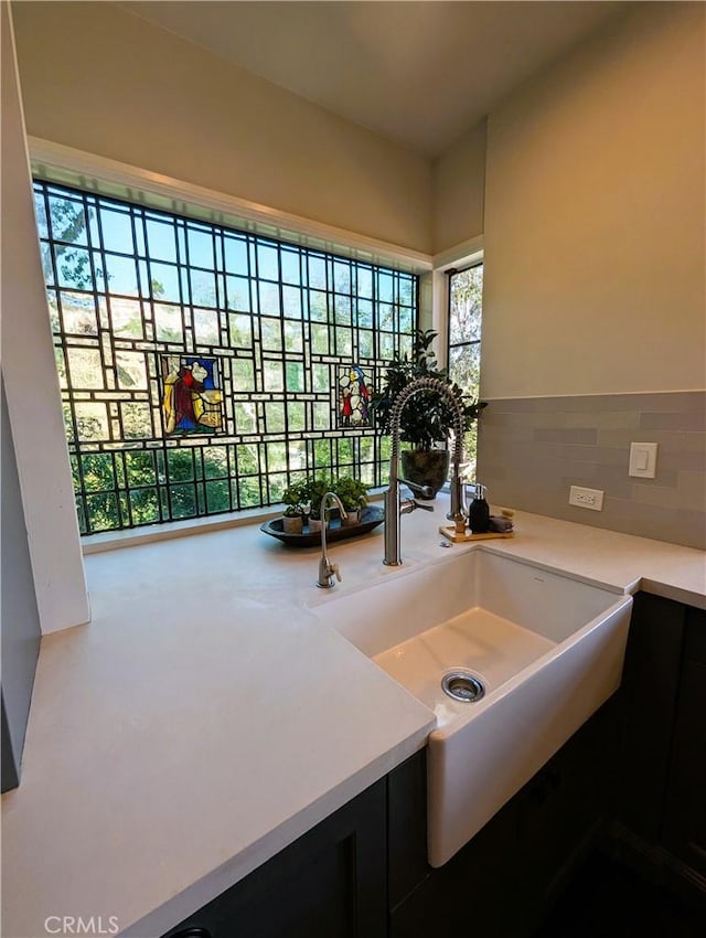 interior details with a sink and light countertops