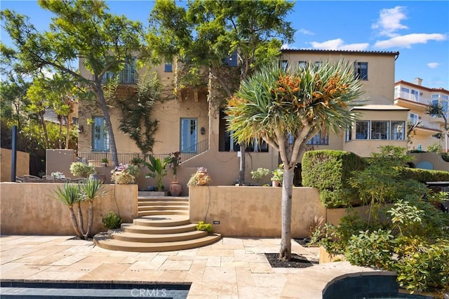 view of front of property featuring stairway and stucco siding