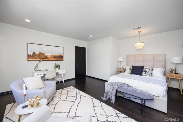 bedroom with dark hardwood / wood-style flooring